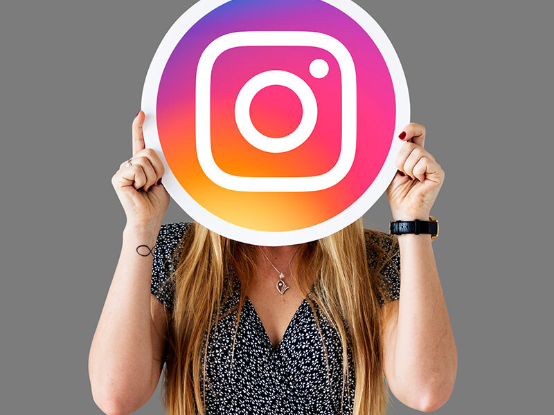 a woman holding a sign over her face